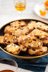 Italian almond biscotti biscuits and sweet wine in a glass on the table. Copy space.