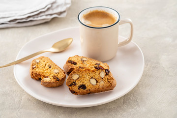 Italian biscotti cookies with a cup of coffee on a light background.
