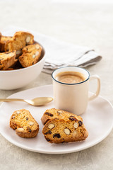 Italian biscotti cookies with a cup of coffee on a light background.