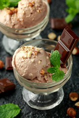 Chocolate Ice Cream with dark chocolate bars and hazelnuts in a glass bowl