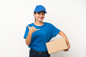 Fototapeta na wymiar Young delivery girl over isolated white background making phone gesture