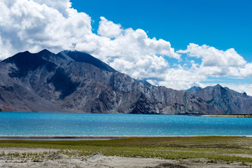 Obraz premium Ladakh, India - Aug 05 2019 - Pangong Lake view from Between Spangmik and Maan in Ladakh, Jammu and Kashmir, India. The Lake is an endorheic lake in the Himalayas situated at a height of about 4350m.