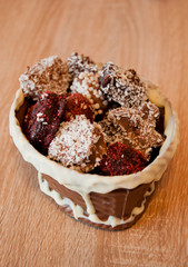 Homemade choco candies in milk chocolate basket. chocolate art figure. sweet food and calorie. Truffles with Nuts and Marzipan. candy shop. sprinkles and topping. homemade chocolate
