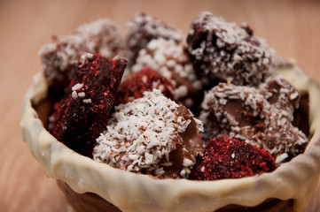 chocolate art figure. sweet food and calorie. Truffles with Nuts and Marzipan. candy shop. sprinkles and topping. homemade chocolate. Homemade choco candies in milk chocolate basket