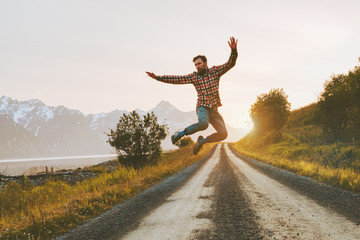 Man jumping over mountain road outdoor travel lifestyle adventure vacations activity in Norway freedom success concept happy positive vibes emotions © EVERST