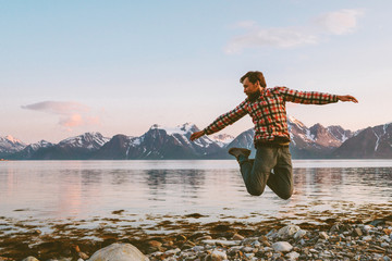 Traveler man jumping outdoor travel active healthy lifestyle adventure vacations in Norway success...