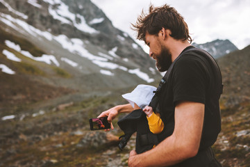 Father hiking with baby taking selfie by smartphone travel in mountains family adventure vacation...