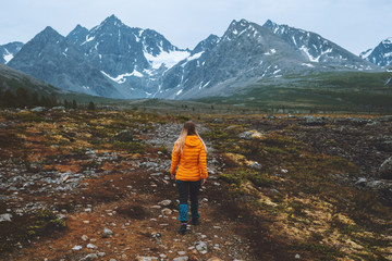 Traveler woman hiking in mountains outdoor adventure vacations alone active healthy lifestyle girl...