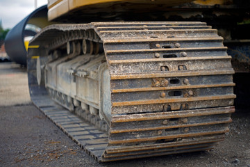 A close-up of the track wheel from a heavy excavator