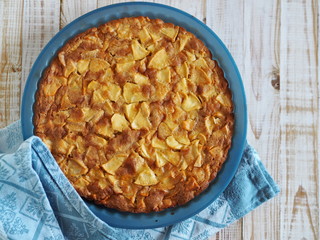 pie or muffin with apples in a baking dish in a blue classic color