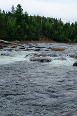 Rapid moving water at Pabineau Falls, New Brunswick, Canada