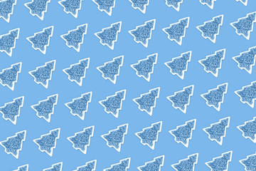 Blue nonpareils cake candy sprinkles in white Christmas tree shaped bowl on pastel blue trending background in flat lay with copy space. Party celebration or bakery concept pattern