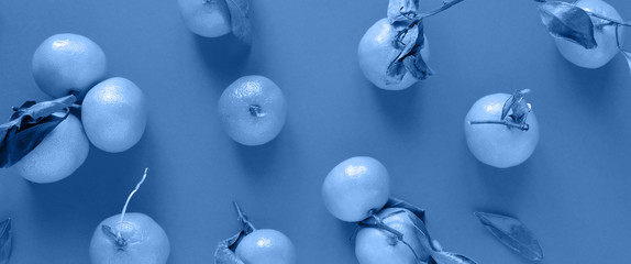Orange tangerine with leaves on background. Toned