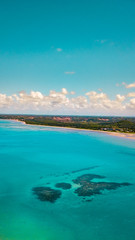 Fototapeta na wymiar Ocean Water Costal Corel Reef Boat Clouds Landscape Palm Threes Brazil Nordeste Plantation Sail Sailing