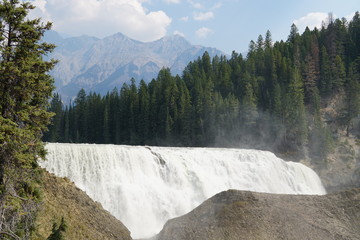 View to the face of Wapta Falls and the beautiful Canadian Rockies in Yoho National Park.