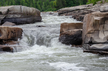 Rapid moving water at Pabineau Falls, New Brunswick, Canada