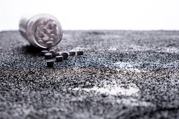 medicine bottle lying on the floor. medicines thrown on the road