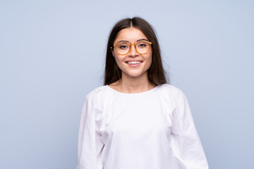 Young woman over isolated blue background with glasses