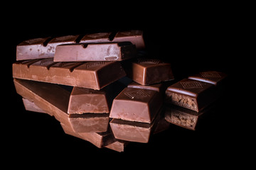 Dark chocolate with reflection on shiny black background