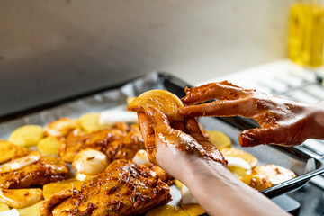 Marinated Raw Chicken Legs with Tomato Sauce, Onions, Rosemary and Potatoes Ready to Bake in Oven.