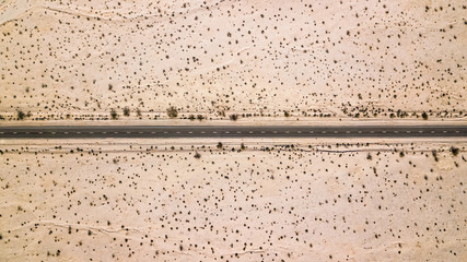 Drone view of a road crossing the desert in Death Valley