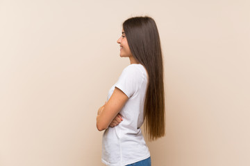 Pretty young girl over isolated background in lateral position