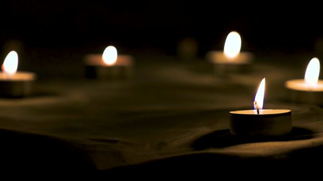 Man puts on the table lighted candles for ritual