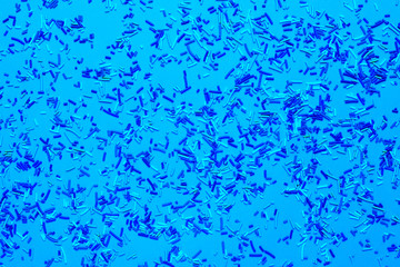 Pink background flat lay with sweet multicolored sprinkles flat lay.Trendy blue tinting