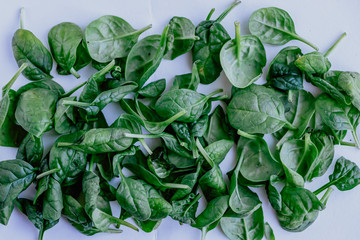 Spinach leaves in the form of an abstract pattern. Trendy ugly food, concept of zero waste life.