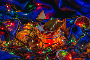 Festive decoration with lights and the cookies on blue.
