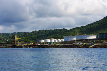 Fototapeta na wymiar Oil storage tanks along the shore, St. Lucia, West Indies