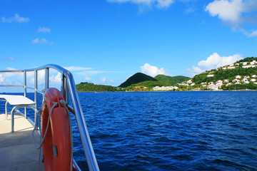 Looking from a boat at the houses and buildings on the shore and hills, St. Lucia, West Indies
