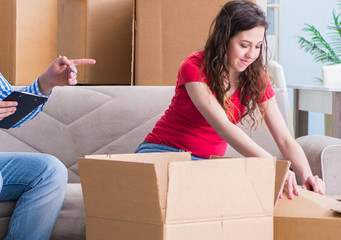 Young pair moving in to new house with boxes