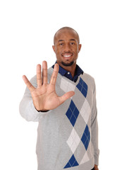 A happy African man holding his hands up, saying no