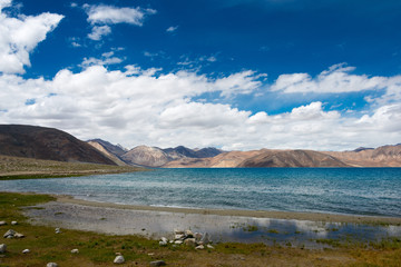 Obraz premium Ladakh, India - Aug 07 2019 - Pangong Lake view from Between Maan and Spangmik in Ladakh, Jammu and Kashmir, India. The Lake is an endorheic lake in the Himalayas situated at a height of about 4350m.