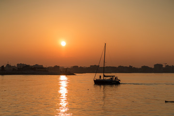 Sunset on the sea of Rimini with a sailboat