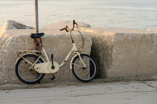an old bike locked in the port of Rimini