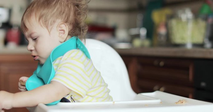 Infant boy fed soup with a spoon