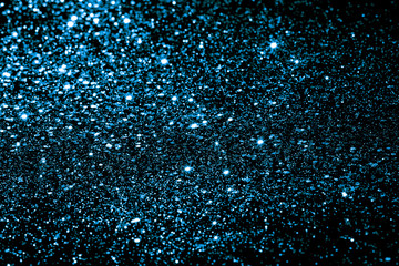 Fototapeta premium Blue bokeh background. Festive New Year and Christmas shiny glitter layout.