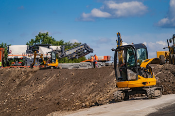 Obraz premium Excavation work on the construction of rural roads. Heavy special machinery. Road repair concept.