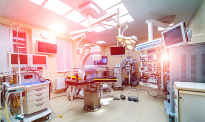 Selective photo of technologically advanced operating room ready for surgery. real modern operating theater with working equipment, lights and computers.