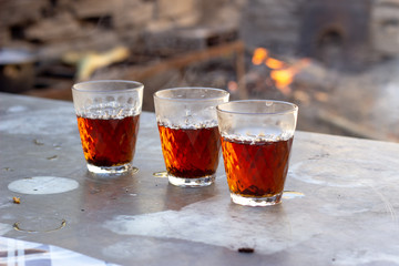 Tea in glass cup on wooden table background. Top view. A glass of tea on the table. Three glasses of tea on the table