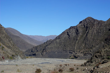 Rocky mountains against the blue sky. Landscape of rocky mountains against the sky. The rocky landscape of the Caucasus mountains. Landscape of the Caucasus mountains
