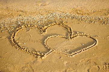 Hearts drawing on the sand 