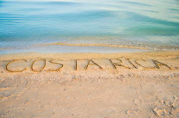 The inscription Costa Rica on sand. Shooting on the beach