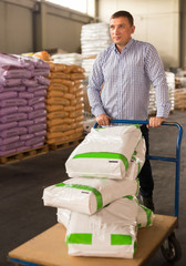 Ordinary male buying compost soil for gardening