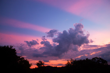 Pink anti-crepuscular rays with clouds during sunset.