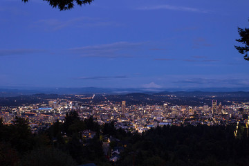 Portland Oregon cityscape skyline and Mt. Hood in the far distance. Night coming over the city of Portland Oregon USA America.