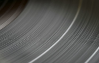 Black vinyl plate with soundtracks on it, selective focus, close-up.