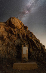 Historic memorial in front of rocks with Milky Way above